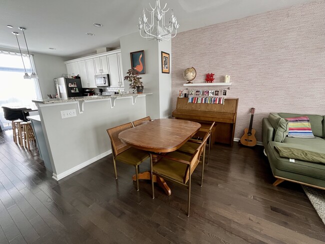 Open-plan kitchen/dining/living area with piano - 4647 S Lake Park Ave