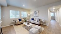 Located at 501 2nd St NE in Puyallup, WA, this well-appointed 2-bedroom, 2-bathroom residence offers a thoughtfully designed single-floor layout with modern finishes throughout. The heart of the home is an open-concept living, dining, and kitchen area bathed in natural light from multiple windows. The kitchen is a standout feature, showcasing two-tone cabinetry with white upper cabinets and warm wood-toned lower cabinets, white quartz countertops, a subway tile backsplash, stainless steel appliances, and a breakfast bar peninsula with pendant lighting. The dining area flows seamlessly into the spacious living room, which includes a wall-mounted mini-split system and recessed lighting. Rich wood-look plank flooring extends throughout the main living areas, adding warmth and continuity. The primary bedroom is generously sized with two large windows, ample natural light, and a dedicated closet. The second bedroom also includes a closet and easy hallway access. Both bathrooms are finished with clean white tile, wood-toned vanities, and tub/shower combinations. Additional highlights include an in-unit laundry, a utility room, and a private patio. The overall ambiance is bright, clean, and contemporary.