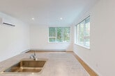 Located at 339 Garden Street in South Burlington, Vermont, this single-floor, 2-bedroom, 2-bathroom unit offers a clean, modern design with a practical and well-organized layout. The open-concept living, dining, and kitchen area serves as the heart of the home, featuring warm hardwood-style flooring, recessed lighting, and multiple large windows that flood the space with natural light and frame views of the surrounding trees. The kitchen is outfitted with white shaker-style cabinetry, stainless steel appliances including a refrigerator, range, and microwave, and a peninsula with a built-in sink and stone-look countertops — ideal for both meal prep and casual dining. Each bedroom is a comfortable size, with the primary bedroom offering generous square footage, a wall-mounted mini-split system for climate control, and a window overlooking the wooded landscape. Both bathrooms are finished in a clean white palette with hardwood-style flooring, vanities with white countertops, and tub-shower combinations. Baseboard heating is present throughout. The unit also includes a dedicated laundry area and six closets providing ample storage. The overall ambiance is bright, neutral, and move-in ready.