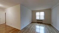 Located at 112 Hoyt Street in Stamford, Connecticut, this one-bedroom, one-bathroom residence offers a straightforward and functional single-floor layout. The living area is bright and welcoming, featuring polished hardwood floors that reflect natural light streaming in through a well-sized window fitted with blinds. Clean white walls provide a neutral canvas throughout, complemented by crisp white baseboards that frame the space neatly. A classic radiator unit beneath the window ensures efficient heating during colder months. The open wall space offers generous flexibility for furniture arrangement and personalization. The overall ambiance is clean, calm, and move-in ready, with a simple and practical design aesthetic that suits a wide range of lifestyles. Situated in Stamford, CT, the residence benefits from its location in a well-connected city with access to local amenities, dining, shopping, and public transportation, making it a convenient option for those looking to settle in Fairfield County.