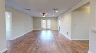 Located at 500 Avalon Way in Brandon, Mississippi, this single-story, 2-bedroom, 1-bathroom home offers a well-designed layout with a comfortable and functional living environment. The open living room is a standout feature, showcasing warm hardwood-style flooring, recessed lighting, a ceiling fan, and a set of French doors that invite natural light and provide outdoor access. A chandelier adds a refined touch to the adjacent dining area, which connects seamlessly to the kitchen via a pass-through window. The kitchen is well-appointed with dark wood cabinetry, stone-look countertops, a tile backsplash, and stainless steel appliances including a dishwasher and over-the-range microwave. The primary bedroom is generously sized, featuring plush carpeting, a ceiling fan with light, and multiple windows that brighten the space. It is complemented by a walk-in closet with wire shelving for ample storage. The second bedroom also features carpet and easy access to the main living areas. The shared bathroom is tastefully finished with a granite-topped vanity, wood-tone cabinetry, a large mirror, and a full soaking tub with shower. A textured ceiling and neutral wall tones throughout lend a cohesive, welcoming ambiance to this well-maintained home.