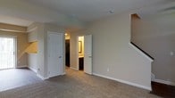 Located at 4150 Silver Springs Ln in Columbus, Ohio, this two-story home offers a thoughtfully planned layout designed for comfortable everyday living. The interior features neutral-toned walls and clean white trim throughout, creating a bright and cohesive aesthetic that flows naturally from room to room. Plush wall-to-wall carpeting adds warmth and comfort underfoot in the living areas and upper-level spaces. The upper floor includes a carpeted bedroom area with direct access to a private bathroom, which features dark cabinetry and a well-appointed vanity with warm lighting. A closet with additional storage space is conveniently located nearby. The staircase connects both levels seamlessly, maintaining the home's open and accessible feel. Recessed lighting and ceiling-mounted fixtures provide consistent illumination throughout the interior. The clean lines, neutral palette, and practical room arrangements make this home a versatile and move-in-ready option in the Columbus, Ohio area. The two-story design maximizes the use of space while maintaining a manageable and functional floor plan suited for a variety of lifestyles.