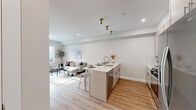 Located at 319 Pennsylvania Ave in Paterson, NJ, this thoughtfully designed one-bedroom, one-bathroom residence offers a well-utilized open-concept layout with modern finishes throughout. Warm hardwood-style flooring flows seamlessly across the entire space, complemented by crisp white walls and recessed lighting that create a bright, contemporary ambiance.

The combined kitchen and living area serves as the heart of the home. The kitchen is outfitted with sleek, light gray cabinetry extending to the ceiling, stainless steel appliances including a gas range, microwave, and French door refrigerator, and a quartz-topped island with a gold-finish faucet that doubles as a casual dining peninsula. The adjoining living area benefits from a large window that brings in natural light.

The bedroom is a comfortable retreat featuring a large window, hardwood-style flooring, and access to a dedicated closet. A second closet provides additional storage convenience. The bathroom is clean and modern, featuring white subway tile surrounding a full soaking tub. An in-unit laundry area adds everyday practicality. The overall design aesthetic is cohesive and contemporary, making this a functional and stylish residence.
