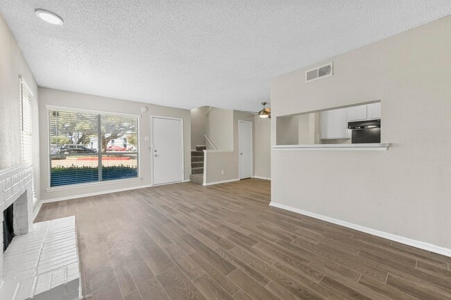 Open floorplan with view of the kitchen and fireplace - Stone Canyon