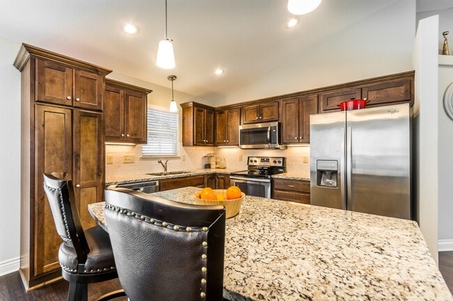 Building Photo - Fenced-in Yard + 3-Car Garage + Finished B...