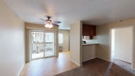Located at 523 Broadway in El Cajon, this single-story unit offers a practical and comfortable layout with a cohesive design throughout. The living area features a combination of wood-look hard flooring and plush carpet, with a ceiling fan overhead and sliding glass doors that open to a private outdoor balcony, allowing natural light to fill the space. The open layout connects the living area directly to the kitchen, which is well-equipped with warm wood cabinetry extending to the ceiling, granite-style countertops, a stainless steel refrigerator, stainless microwave, and a black electric range. A double stainless steel sink and a window overlooking the exterior complete the kitchen. The bedroom is carpeted and features a ceiling fan with light, a walk-in closet, and a window with outdoor views, creating a bright and airy feel. The bathroom includes a wood-toned vanity with granite-style countertop, a large mirror with overhead lighting, and a full tub and shower combination. Neutral wall tones and consistent finishes throughout give the unit a clean, move-in-ready ambiance.