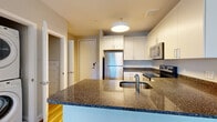 Located at 7720 Harkins Rd in Lanham, MD, this well-appointed 3-bedroom, 2-bathroom residence offers a thoughtfully designed single-floor layout. The modern kitchen serves as a central highlight, showcasing granite countertops, crisp white cabinetry, stainless steel appliances including a refrigerator, electric range, built-in microwave, and dishwasher, along with a peninsula with an undermount sink — ideal for both cooking and casual dining. Light hardwood-style flooring runs through the kitchen and select areas, adding warmth to the space. The three bedrooms are comfortably sized, with the spacious primary bedroom offering generous square footage, plush carpeting, and natural light from large windows with views of the surrounding neighborhood. The additional bedrooms also feature large windows, neutral tones, and a mix of carpet and hardwood-style flooring. Two well-appointed closets provide organized storage, including a walk-in closet with wire shelving systems. The bathrooms are finished with large-format tile flooring and clean white subway tile surrounds in the tub/shower areas. The overall aesthetic is clean, contemporary, and move-in ready, offering a comfortable and functional living environment.