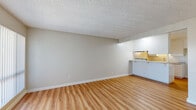 Located at 744 N Azusa Ave in West Covina, California, this 2-bedroom, 2-bathroom single-floor residence offers a practical and comfortable layout. The living room is bright and open, featuring warm light wood laminate flooring, neutral beige walls, a textured ceiling, and a large sliding glass door with vertical blinds that fills the space with natural light. Adjacent to the living area, the kitchen is efficiently designed with white cabinetry, granite-patterned countertops, a black electric range, a stainless steel sink, and a peninsula breakfast bar that opens toward the living room — ideal for casual dining or entertaining. Both bedrooms are carpeted for comfort and include built-in closets for storage. The primary bedroom is notably spacious and features double sliding closet doors, a window with natural light, and a ceiling fan in the secondary bedroom adds additional comfort. The bathrooms are well-appointed; one features a large vanity with white shaker-style cabinetry, white quartz countertop, a bold-framed mirror, and light wood flooring. The overall ambiance is clean, neutral, and move-in ready, with consistent finishes throughout that create a cohesive, functional living environment.