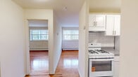 Located at 250 Beverly Blvd in Upper Darby, PA, this one-bedroom, one-bathroom residence is thoughtfully laid out across a single floor. Gleaming hardwood floors run throughout the space, lending warmth and continuity to every room.

The living room is generously proportioned, filled with natural light from large windows, and flows into a defined dining area, creating a comfortable and cohesive everyday living space. The kitchen is outfitted with white cabinetry, a gas range, and classic subway tile backsplash — a clean, practical setup for home cooking.

A central hallway connects the main living areas to the private quarters. The bedroom is a well-sized retreat featuring a closet with double doors, a window with outdoor views, and the same warm hardwood flooring found throughout the unit. Two additional closets provide ample storage across the space.

The bathroom offers a white vanity with under-cabinet storage, a mirrored medicine cabinet, and tile wainscoting, maintaining the clean, neutral palette of the rest of the home. Baseboard heating is present throughout, and a window AC unit is installed in the living area. The overall aesthetic is bright and understated, with white walls and natural wood tones creating a welcoming, move-in-ready environment.