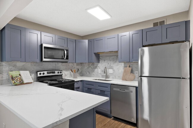 Quartz Countertops and Stainless Steel Appliances - Mill House at East Cobb Apartment Homes