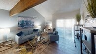 Located at 1609 W Glendale Ave in Phoenix, Arizona, this single-floor home offers a thoughtfully designed layout with a blend of character and modern updates throughout. The living room serves as the centerpiece of the home, showcasing dramatic vaulted ceilings accented by a striking exposed wood beam. Light wood-style flooring flows throughout, complemented by large sliding glass doors dressed with vertical blinds that invite natural light and provide access to the outdoors. The living area comfortably accommodates both a seating arrangement and a dedicated workspace, making it as functional as it is inviting. The kitchen is well-appointed with white shaker-style cabinetry, granite-look countertops, a subway tile backsplash, recessed lighting, and stainless steel appliances including a gas range and refrigerator. The primary bedroom is bright and airy, featuring clerestory windows and a sliding glass door for additional natural light and outdoor access. A secondary bedroom offers hardwood-style flooring and a window for natural light, providing a comfortable and versatile space. The bathroom includes a glass-enclosed shower stall and built-in shelving for convenient storage. This home offers a practical and attractive living environment in a central Phoenix location.