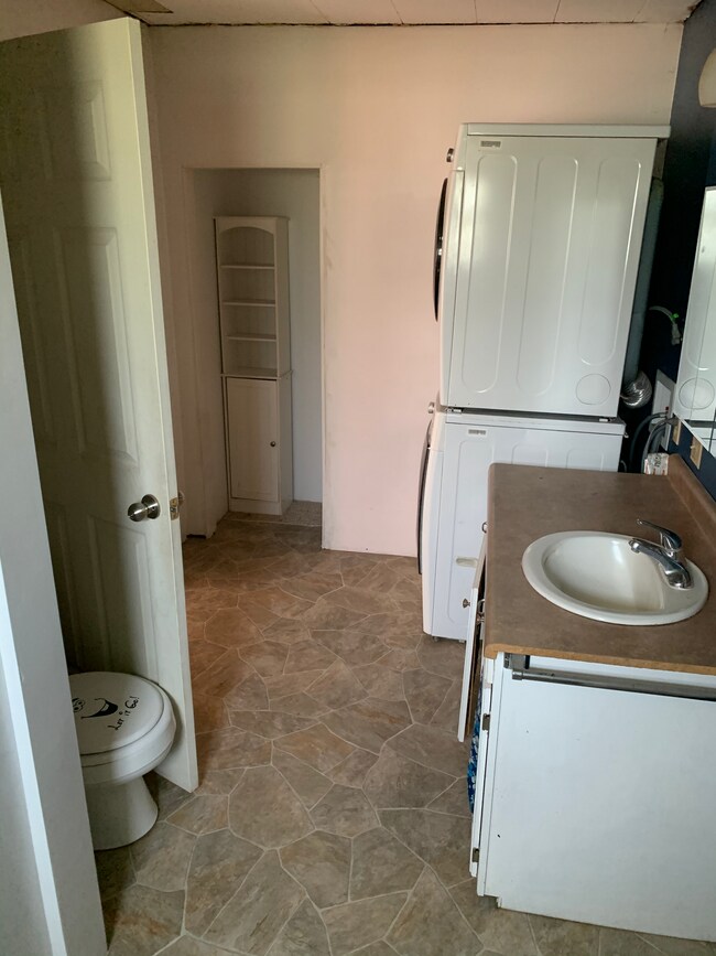 Bathroom. Sink, toilet, washer/dryer, and storage space. Newly remodeled. - 410 Church St.