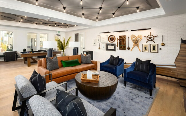 Relaxed Lounge with Leather Sofa, Velvet Chairs, and Arcade Decor - Harpeth Heights Apartments