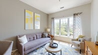 Located at 500 Bristol Blvd in Somerset, NJ, this single-floor residence offers a thoughtfully designed layout with a cohesive modern aesthetic throughout. The living room serves as a welcoming centerpiece, featuring large multi-pane windows that flood the space with natural light and frame views of the surrounding greenery. Neutral gray walls complement the contemporary styling, creating a calm and inviting atmosphere.

The kitchen is a standout feature, equipped with rich dark espresso cabinetry extending floor to ceiling, light stone countertops, a subway tile backsplash, and hardwood-style flooring. A spacious island provides additional prep and dining space, making the kitchen both functional and visually striking.

The space includes two well-proportioned bedrooms. One features soft, neutral tones with plush carpeting, a large window with outdoor views, and generous storage. The second bedroom showcases a deeper slate-blue accent wall, creating a more intimate and sophisticated ambiance.

The bathroom mirrors the kitchen's design language, with matching dark wood cabinetry, a white vanity countertop, a large mirror with overhead lighting, and tile flooring — offering a clean, polished finish. Overall, the space combines modern design with practical functionality in a comfortable residential setting.