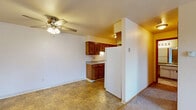 Located at 3125 West 4th Street in Appleton, Wisconsin, this single-floor unit offers a practical and comfortable layout comprising one bedroom and two full bathrooms. The open living area features soft carpeting, a ceiling fan with light fixture, and a sliding glass door that fills the space with natural light while providing outdoor access. Baseboard heating and a wall-mounted AC unit ensure year-round comfort. The galley-style kitchen is well-equipped with warm wood cabinetry extending to the upper walls for ample storage, a double-basin sink, and white appliances including a refrigerator and range, all set on durable tile flooring. The bedroom is a comfortable size with plush carpet, a window with blinds offering natural light, baseboard heating, and a louvered closet for organized storage. Both bathrooms are functional and tidy; the primary bath features a wide vanity with a large mirror, tile flooring, and a full tub-shower combination with classic tiled surround. The second bathroom mirrors this design with a tub-shower and tile surround. The neutral color palette and clean lines throughout the unit create a calm, move-in-ready atmosphere suitable for easy personalization.