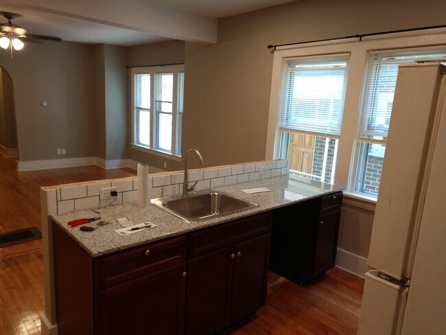 Kitchen looking into LR Wall Top Trim Added After Photo - 111 Boyden St