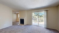 Located at Lake Heights Drive in Everett, Washington, this well-appointed two-bedroom, two-bathroom residence offers a comfortable and practical single-floor layout. The living room serves as the heart of the home, featuring a classic fireplace, plush carpeting, and a sliding glass door that opens onto a private balcony overlooking lush, mature trees — filling the space with natural light and greenery views.

The galley-style kitchen is equipped with wood-toned cabinetry, light countertops, a stainless steel refrigerator, and matching appliances, complemented by durable wood-look vinyl flooring and track lighting overhead.

Both bedrooms are generously proportioned and finished with soft carpet and baseboard heating. The primary bedroom benefits from direct access to one of the two bathrooms, which also features a closet — adding convenience and privacy. The second bedroom includes a closet and a window that frames pleasant outdoor views. The bathrooms are finished with warm wood-toned vanities, light countertops, and wood-look flooring, maintaining a cohesive aesthetic throughout.

Textured ceilings are consistent across the home, and a connecting hallway ties the layout together efficiently. This residence offers a blend of comfort, practicality, and natural surroundings.