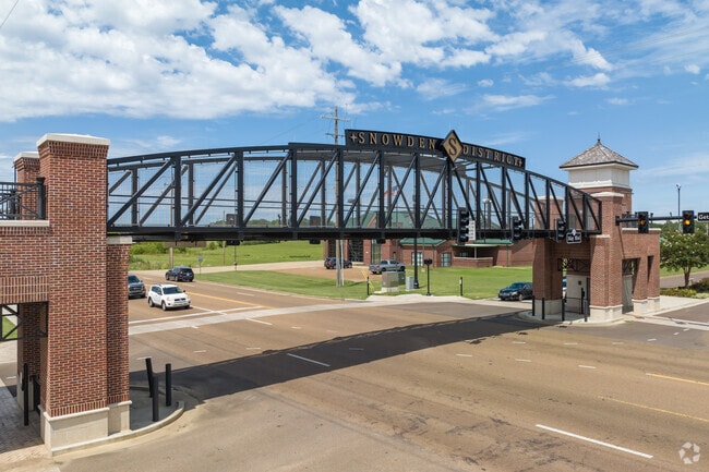 A pedestrian bridge crosses over busy Getwell Rd in the Snowden District.