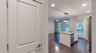 Located at 401 E Oglethorpe Ave in the heart of historic Savannah, Georgia, this well-appointed one-bedroom, one-bathroom residence offers a thoughtfully designed layout with modern finishes throughout. The open-concept kitchen serves as the centerpiece of the living area, showcasing a large granite-topped island with an undermount sink and a striking rectangular pendant light fixture above. Crisp white cabinetry extends to the ceiling, complemented by a geometric tile backsplash and a full suite of stainless steel appliances, including a French door refrigerator, electric range, over-the-range microwave, and dishwasher. Dark hardwood-style flooring runs throughout the main living areas, adding warmth and contrast to the light-toned walls. The bedroom is carpeted for comfort and is bathed in natural light through multiple large windows that frame views of the surrounding Savannah streetscape. The bathroom features a glass-enclosed shower adorned with elegant marble-look tile and wood-style flooring. A dedicated in-unit stacked washer and dryer adds everyday convenience. Built-in shelving in the living area and a closet round out the functional storage options in this clean, contemporary Savannah residence.