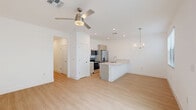 This modern two-story home in Saint Cloud, Florida offers a thoughtfully designed layout across two floors. The ground level features an open-concept living, dining, and kitchen area bathed in natural light, with light-toned luxury vinyl plank flooring running throughout. The contemporary kitchen is a standout, equipped with stainless steel appliances including a French door refrigerator, electric range, and microwave, complemented by two-tone cabinetry, a large peninsula with a quartz countertop and undermount sink, and stylish pendant lighting. A convenient half bath with a pedestal sink is also located on the main floor, along with an attached garage and pantry. Upstairs, the home continues with two generously sized bedrooms, including a spacious primary suite with walk-in closet and dedicated bathroom. A second full bathroom serves the additional bedroom, and a dedicated laundry area adds everyday convenience. The hallways are bright and clean, featuring recessed lighting and crisp white walls. Throughout the home, the clean white palette, light wood flooring, and modern fixtures create a cohesive, contemporary aesthetic that feels fresh and move-in ready.