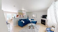 This two-story, 2-bedroom, 2-bathroom home in Kansas City, Missouri offers a well-designed layout spread across two floors. The main level opens into a bright and inviting living room featuring light hardwood-style flooring, a gas fireplace, track lighting, and large windows dressed with sheer curtains that allow natural light to fill the space. The open-concept design connects the living area seamlessly to the kitchen, which is outfitted with light wood cabinetry, stainless steel appliances including a refrigerator, range, and microwave, a double sink, a dishwasher, and a peninsula that overlooks the living room. A cozy dining nook with a chandelier completes the kitchen area. Upstairs, the spacious primary bedroom features carpet flooring, a ceiling fan, and a closet, while the second bedroom mirrors a similar comfortable layout with carpet, a ceiling fan, and a window with views of greenery. Both bathrooms are functional and neatly appointed. A hallway and additional closets provide ample storage throughout. The home's clean, neutral palette and flowing two-floor layout make it a practical and comfortable residence in the heart of Kansas City.