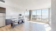This sleek, contemporary apartment offers a perfect blend of style and functionality. Spanning 960 square feet, the space boasts 4 bedrooms and 2 bathrooms, making it ideal for families or those seeking extra room. The highlight of this property is its abundance of natural light, courtesy of floor-to-ceiling windows that frame breathtaking city and water views.

The interior showcases a modern aesthetic with clean lines and a neutral color palette. Light wood-look flooring runs throughout, complementing the white walls and creating an airy atmosphere. A standout feature is the exposed concrete column, adding an industrial touch to the otherwise minimalist design.

The kitchen is a chef's dream, outfitted with high-end stainless steel appliances, ample cabinetry in a two-tone design, and a spacious quartz countertop. The open-concept layout seamlessly connects the kitchen to the living areas, perfect for entertaining.

Bathrooms are designed with a contemporary flair, featuring sleek fixtures, large mirrors, and modern vanities. The bedrooms, including the 130 square foot primary suite, offer generous space and large windows for natural illumination.

Located at 1405 Point St in Baltimore, this apartment combines urban living with stunning views, making it a highly desirable residence in the heart of the city.