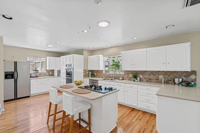 large kitchen with island and seating - 14024 Peach Grove St