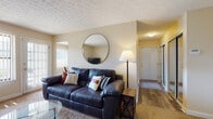 Located at 4334 Appian Way W in Columbus, Ohio, this single-floor residence offers a well-organized layout designed for comfortable everyday living. The entryway features durable wood-look flooring and a mirrored sliding closet, providing both style and practical storage from the moment you step inside.

The living room is a relaxed and inviting space, finished with plush carpeting and textured ceilings. Natural light filters in through vertical blinds, creating a bright and comfortable atmosphere. The space flows naturally into a dedicated dining area, which includes its own window with outdoor views — ideal for everyday meals or casual entertaining.

The kitchen is equipped with warm oak cabinetry, a white electric range with overhead ventilation, and a full-size refrigerator, all set atop wood-look flooring that ties the functional space together.

A versatile additional room, currently configured as a home office, benefits from two large windows that flood the space with natural light and offer views of the surrounding greenery, making it well-suited for work or as a flexible living space.

The bedroom is a calm retreat with soft carpeting and warm ambient lighting. The bathroom features tile flooring, a vanity with oak cabinetry, and a bathtub. Completing the unit is a dedicated in-unit laundry area with a washer, shelving, and hanging storage for added convenience.