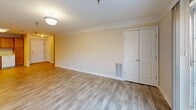 Located at 2195 Mountain View Rd in Stafford, Virginia, this two-bedroom, one-bathroom home offers a well-organized single-floor layout designed for comfortable, everyday living. The open-concept living and dining area is bright and inviting, featuring light wood-tone flooring, crown molding, and a sliding glass door that opens to a private balcony, filling the space with natural light. The kitchen is fully equipped with warm honey-toned oak cabinetry offering generous storage, white appliances including a range, dishwasher, refrigerator, and microwave, along with light countertops and a stainless steel sink. The spacious primary bedroom provides a comfortable retreat with its own closet and a large window overlooking greenery. The second bedroom is well-sized with its own closet, ideal for guests or a home office. The bathroom is fitted with accessibility features including multiple grab bars near the tub and toilet, providing added safety and convenience. Throughout the home, four closets offer abundant storage, and a dedicated laundry area adds everyday practicality. The neutral, warm-toned walls and consistent flooring create a cohesive and functional living environment throughout.