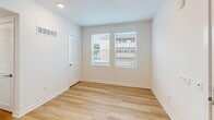 Located at 1024 Romneya Dr in Anaheim, California, this single-floor residence offers two bedrooms and two bathrooms within a thoughtfully arranged floor plan. The kitchen is a standout feature, showcasing white shaker cabinetry, a subway tile backsplash, light wood-style flooring, and a full suite of stainless steel appliances including a refrigerator, range, built-in microwave, and dishwasher. Recessed lighting and a window brighten the space, which flows openly into the adjacent living area.

The two bedrooms are carpeted and finished with crisp white walls, offering a clean and neutral palette. Each room features window blinds that allow for natural light and outdoor views of the surrounding neighborhood. The primary bedroom is generously proportioned and connects conveniently to the hallway.

The two bathrooms are finished in a modern, all-white aesthetic. One features a tub-shower combination with subway tile surround and chrome fixtures, while the other includes a walk-in shower with sliding glass doors and matching tile work. A dedicated closet and a central hallway complete the layout, providing practical storage and easy circulation throughout the home.