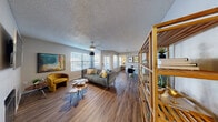 Located at 3625 S Decatur Blvd in Las Vegas, NV, this two-bedroom, three-bathroom residence offers a well-organized single-floor layout designed for comfortable everyday living. The living room serves as the heart of the home, featuring warm wood-style flooring, a ceiling fan, textured ceilings, and large windows fitted with blinds that allow natural light to fill the space while offering views of surrounding greenery. The open flow connects seamlessly to a dining area, making the space feel welcoming and functional. The kitchen is equipped with warm-toned wood cabinetry, dark granite countertops, black appliances including a range, microwave, and refrigerator, plus a double-basin sink — a practical and well-appointed cooking space. The primary bedroom offers a comfortable footprint with wood-style flooring, a dedicated closet, and direct access to a private en-suite bathroom featuring granite countertops and wood cabinetry. The second bedroom includes a window with natural light and ample room. Additional bathrooms are finished consistently with granite counters and wood vanities. A dedicated laundry room houses a full-size washer and dryer with overhead shelving for added storage. Two closets throughout the unit provide practical organization solutions.