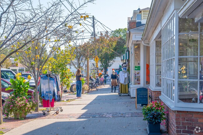 Guilford locals stroll past boutiques and independent shops.