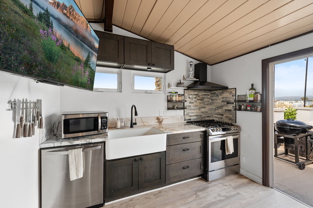 Stove, dish washer, motion censored sink, and microwave. 55" TV mounted - 111 8th St