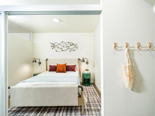 Discover a peaceful haven in the roomy bedrooms at Modera Northgate, designed to be your personal sanctuary with ample space and thoughtful touches for ultimate relaxation. - Modera Northgate