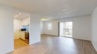 Located in Temple Terrace, Florida, this single-story, one-bedroom, one-bathroom home offers a clean, functional layout with a bright and neutral aesthetic throughout. The open living and dining area is finished with light-toned laminate flooring and crisp white walls, creating an airy atmosphere. Large sliding glass doors allow natural light to flow in and provide access to the exterior. The kitchen features a peninsula layout with granite countertops, white cabinetry extending to the ceiling for ample storage, a stainless steel refrigerator, and a built-in cooktop, making it both practical and visually appealing. A secondary room with matching laminate floors and a window with blinds offers flexibility as an office or additional living space. The generously sized primary bedroom is carpeted for comfort and includes a ceiling fan, a wide closet with bifold doors, and a window overlooking the outdoors. The full bathroom is neatly appointed with wood-look tile flooring, a combined tub and shower, a toilet, and a vanity topped with granite counters. Throughout the home, consistent finishes and a light color palette contribute to a cohesive, well-maintained feel.