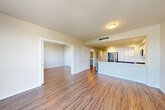 This well-appointed 2-bedroom, 2-bathroom residence at 888 Fourth St in Santa Rosa, California offers a thoughtfully designed single-level floor plan. The open-concept living, dining, and kitchen area serves as the heart of the home, featuring warm wood-look flooring that flows throughout the main living spaces. Large windows allow natural light to fill the living area, creating a bright and welcoming atmosphere.

The contemporary kitchen is equipped with stainless steel appliances, including a range, microwave, and refrigerator. Grey shaker-style lower cabinets are paired with crisp white upper cabinetry, complemented by sleek white quartz countertops and a double undermount sink — providing ample prep and storage space.

Both bedrooms are comfortably sized and include sliding-door closets and wood-look flooring. The primary bedroom connects to a dedicated bathroom featuring an accessible roll-in shower with grab bars and a grey vanity with a white countertop set on large-format tile flooring. The second bathroom offers a full tub and shower combination, also with grab bars and tile flooring. Additional highlights include three closets, a dedicated laundry area, and a welcoming entrance.