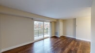 Located at 4809 Columbia Rd in North Olmsted, Ohio, this one-bedroom, one-bathroom residence offers a well-organized single-floor layout designed for comfortable everyday living. Rich, dark hardwood flooring runs consistently throughout the space, creating a warm and cohesive aesthetic from room to room. The living room serves as the heart of the unit, highlighted by a large sliding glass door that opens to a private balcony, flooding the area with natural light and offering pleasant outdoor views of the surrounding neighborhood. An adjacent dining area flows naturally from the living space, supported by overhead lighting and clean neutral wall tones. The galley-style kitchen is efficiently designed with white shaker cabinetry, white quartz countertops, a stainless steel sink, and stainless steel appliances including a refrigerator and gas range — maximizing both function and style. The bedroom is a comfortable, well-proportioned retreat featuring a window with natural light and direct access to a generously sized walk-in closet with wire shelving for organized storage. Two additional closets provide further storage throughout the unit. The bathroom features a white vanity with quartz countertop, a framed mirror, and brushed nickel fixtures. A utility room completes the layout.