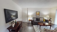 This single-floor residence offers a thoughtfully designed layout across several functional living spaces. The living room serves as the heart of the home, featuring rich dark hardwood-style flooring, neutral walls, and a textured ceiling. The space comfortably accommodates a seating area and media console, creating a welcoming environment for relaxing or entertaining. Adjacent to the living room, the dining area provides generous space for a full-sized dining table and chairs, accented by a ceiling fan with lighting and a window that allows natural light to filter in. The kitchen is well-equipped with warm maple cabinetry, dark granite-style countertops, a double stainless steel sink, and black appliances including a range and over-the-range microwave, complemented by recessed lighting and wood-style flooring. The primary bedroom features plush carpeting, a window with blinds, and direct access to a private en-suite bathroom with a stand-alone shower. A second bedroom with carpet flooring and a window offers flexible use as a guest room or home office. A second full bathroom includes a tiled tub-shower combination. Throughout the residence, the clean, neutral palette and consistent finishes create a cohesive and comfortable atmosphere.