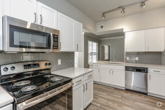 Modern open kitchen with ample natural lighting - The Grayson at Baybrook