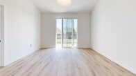 This contemporary apartment, located at 700 W Capitol Dr in Hartland, WI, offers a generous 4,070 square feet of living space across two floors. The unit features two bedrooms, including a spacious 160 sq ft primary bedroom, and two full bathrooms. The interior showcases a modern design with clean lines and a neutral color palette.

Throughout the apartment, warm wood-look flooring creates a cohesive and inviting atmosphere. The living areas are bright and airy, with large windows that allow natural light to flood the space. Some rooms feature sliding glass doors leading to outdoor areas, enhancing the connection to the exterior environment.

The kitchen is a highlight, boasting sleek white cabinetry, granite countertops, and stainless steel appliances. A central island provides additional workspace and casual seating. Pendant lighting adds a touch of contemporary style.

Bedrooms are generously sized and well-lit, with ample closet space. The bathrooms feature modern fixtures, including glass-enclosed showers and built-in storage. A unique barn-style sliding door adds character to one of the rooms.

The apartment's layout includes two staircases, two hallways, and a combined kitchen and living room area, offering both functionality and flow. With its blend of space, style, and modern amenities, this apartment presents an attractive option for those seeking a contemporary living experience in Hartland.