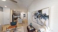 This well-designed single-floor residence in Humble, TX offers a thoughtfully laid-out open-concept floor plan that seamlessly connects the main living areas. The kitchen is a standout feature, showcasing dark wood-grain cabinetry, stainless steel appliances, light wood-style flooring, and a granite-topped island with a undermount sink and pendant lighting overhead — ideal for both cooking and casual dining. The living room is bright and welcoming, featuring a ceiling fan, an accent wall in a rich teal tone, and windows that invite natural light while offering a connection to the outdoors via a private door. The bedrooms are comfortably sized, each featuring ceiling fans, large windows with natural light, and light wood-style flooring. The primary suite includes a walk-in closet with generous shelving and hanging space, as well as a bathroom featuring dark wood cabinetry, granite countertops, a dual vanity with a well-lit mirror, and a tiled shower. A dedicated laundry area with a washer and dryer is also conveniently accessible from within the unit. Neutral tones, recessed lighting, and consistent hardwood-style flooring throughout create a cohesive, modern aesthetic across the entire space.