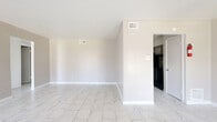 Located at 8917 S Gessner Rd in Houston, Texas, this single-story, 3-bedroom, 2-bathroom home offers a clean and cohesive aesthetic throughout. Marble-look porcelain tile flooring flows seamlessly across every room, lending a bright and polished feel to the entire space.

The living room is generously sized, filled with natural light from multiple windows, and features a pendant light fixture and a front entry door that adds to the open, welcoming atmosphere. The kitchen is efficiently laid out with gray cabinetry, granite-look countertops, a double stainless steel sink, a dishwasher, a refrigerator, and a stylish subway tile backsplash with a mixed-pattern design.

The spacious primary bedroom offers a comfortable footprint, while the additional bedrooms include ceiling fans and windows that bring in natural light and outdoor views. A hallway connects the main living areas to the bedrooms and bathrooms.

Both bathrooms feature marble-look tile flooring and tub/shower combinations with large-format marble-style wall tiles. One bathroom includes a vanity with granite-look countertops and under-sink cabinetry. The home's neutral warm-gray wall tones throughout create a calm, move-in-ready environment.