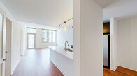 Located in Chicago's vibrant Old Town neighborhood, this one-bedroom, one-bathroom unit at 1225 N Wells St offers a well-designed layout across a single floor. Warm hardwood flooring flows throughout the open-concept living and kitchen area, creating a cohesive and inviting atmosphere. The living room is bright and airy, benefiting from clean white walls and an open feel that maximizes the sense of space.

The kitchen is a standout feature, showcasing rich dark-stained cabinetry, white countertops, a tile backsplash, and a full suite of stainless steel appliances including a gas range, built-in microwave, and French door refrigerator. Track lighting and elegant pendant lights illuminate the space, while a peninsula with an undermount sink adds both functionality and a natural division between the kitchen and living area.

The bedroom is carpeted for comfort and features dual closets, providing generous storage. Floor-to-ceiling windows frame sweeping views of the Chicago skyline, flooding the room with natural light. The bathroom is finished with tile flooring, a dark-framed vanity mirror, white countertop, and clean, neutral finishes throughout. This unit combines modern finishes with a practical layout in one of Chicago's most walkable and sought-after neighborhoods.