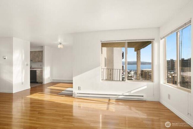 Open concept living and dining room with lake view - 9030 Seward Park Ave S