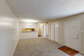Located at 10530 Florida Blvd in Baton Rouge, Louisiana, this one-bedroom, one-bathroom unit offers a practical and well-organized single-floor layout. The combined living and dining area serves as the heart of the home, featuring plush neutral-toned carpet, a textured ceiling, and a decorative chandelier that adds a touch of warmth. A pass-through counter connects this open area to the kitchen, promoting a sense of openness between the spaces. The kitchen is efficiently designed with wood-look flooring, white cabinetry providing ample storage, a double-basin sink, and a full-size refrigerator. A pantry offers additional storage convenience. The bedroom is a comfortable and well-sized retreat, carpeted in neutral tones and featuring a window that allows natural light to fill the room. Multiple closets throughout the unit — including a sliding-door closet — provide generous storage options. The bathroom includes a vanity with under-sink cabinetry, a wall mirror, and wood-look flooring. The unit's consistent neutral color palette and practical layout create a clean, functional living environment suitable for everyday comfort.