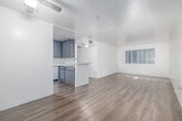 Located at 7300 Hazeltine Ave in the Van Nuys neighborhood of Los Angeles, this single-floor, 3-bedroom, 1-bathroom unit offers a clean and functional layout. Light wood-style flooring runs consistently throughout the entire space, lending a cohesive, modern feel to each room.

The open living area provides a comfortable gathering space and flows naturally toward the kitchen, which is equipped with gray cabinetry, white countertops, a gas range, and a full-size refrigerator — offering practical functionality in a compact footprint.

Each of the three bedrooms features the same light flooring and is fitted with vertical blinds on windows that invite natural light and provide views of surrounding greenery. The primary bedroom includes a sliding closet, adding useful storage. The additional bedrooms are well-proportioned and bright, making them versatile for various uses.

The single bathroom is clean and efficiently designed, featuring a combined tub and shower enclosed with frosted sliding glass doors, a white vanity with countertop, and continued wood-style flooring.

Throughout the unit, the neutral white and cream-toned walls complement the light flooring to create a bright, airy atmosphere. The consistent finishes and practical layout make this a straightforward, move-in-ready space in a well-connected Los Angeles neighborhood.