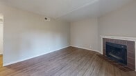 Located at 4729 Manzanita Ave in Carmichael, CA, this one-bedroom, two-bathroom single-floor residence offers a thoughtfully arranged layout with consistent wood-style flooring running throughout. The living room serves as the heart of the home, highlighted by a tile-surround fireplace and a sliding glass door that opens to a private balcony, filling the space with natural light and outdoor views. A textured ceiling adds character to the living area.

The kitchen is efficiently designed with white cabinetry, granite-style countertops, a peninsula breakfast bar, and white appliances including a refrigerator, dishwasher, and range. A window above the sink brings in additional natural light, keeping the space bright and functional.

The bedroom is a comfortable retreat featuring a large window with outdoor views, wood-style flooring, a textured ceiling, and a sliding-door closet providing ample storage. Both bathrooms are well-appointed; one features a wide vanity with granite-style countertops, white cabinetry, and a large mirror, while the second includes a full shower-tub combination with clean white finishes. A hallway connects the rooms, completing this efficiently organized and move-in ready residence.