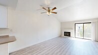 Located at 5858 Morgan Place in Stockton, CA, this 2-bedroom, 2-bathroom single-floor unit offers a well-organized layout with a blend of comfort and functionality. The living room is a standout space, featuring vaulted ceilings that create an airy, open feel, light luxury vinyl plank flooring, and a classic brick fireplace with a gold-trimmed glass door that serves as a focal point. A sliding glass door leads to a private balcony, filling the space with natural light. The galley-style kitchen is efficiently designed with ample white cabinetry, granite-look countertops, white appliances including a refrigerator and electric range, a stainless steel sink, and a skylight that brightens the workspace. Both bedrooms are carpeted and feature sliding closet doors, with the primary bedroom offering direct balcony access. The two bathrooms are clean and practical — one includes a standalone glass-enclosed shower with light wood-look flooring, while the other features a full tub-shower combo and a single vanity with a large mirror. A connecting hallway ties all rooms together, making for an efficient and comfortable floor plan throughout.