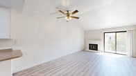 Located at 5858 Morgan Place in Stockton, CA, this 2-bedroom, 2-bathroom single-floor unit offers a well-organized layout with a blend of comfort and functionality. The living room is a standout space, featuring vaulted ceilings that create an airy, open feel, light luxury vinyl plank flooring, and a classic brick fireplace with a gold-trimmed glass door that serves as a focal point. A sliding glass door leads to a private balcony, filling the space with natural light. The galley-style kitchen is efficiently designed with ample white cabinetry, granite-look countertops, white appliances including a refrigerator and electric range, a stainless steel sink, and a skylight that brightens the workspace. Both bedrooms are carpeted and feature sliding closet doors, with the primary bedroom offering direct balcony access. The two bathrooms are clean and practical — one includes a standalone glass-enclosed shower with light wood-look flooring, while the other features a full tub-shower combo and a single vanity with a large mirror. A connecting hallway ties all rooms together, making for an efficient and comfortable floor plan throughout.