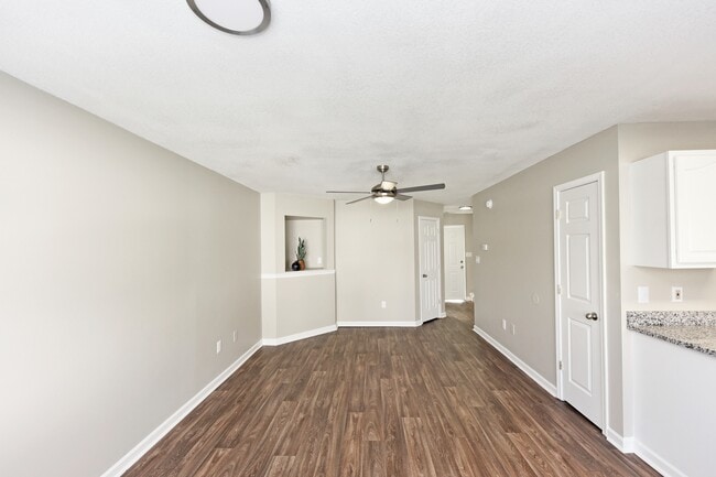 Spacious living room with hardwood-style flooring - Emory Cove